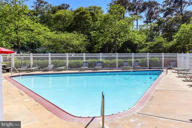 a view of a swimming pool with a lounge chair