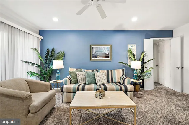 a living room with furniture and a potted plant