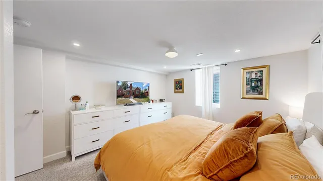 a bed room with a bed and a television