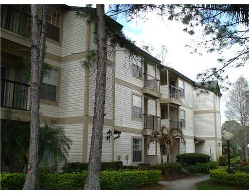 1908 Lake Atriums Circle, Unit 10 Orlando, FL 32839 - Photo 1 of 1 a front view of a house with a yard