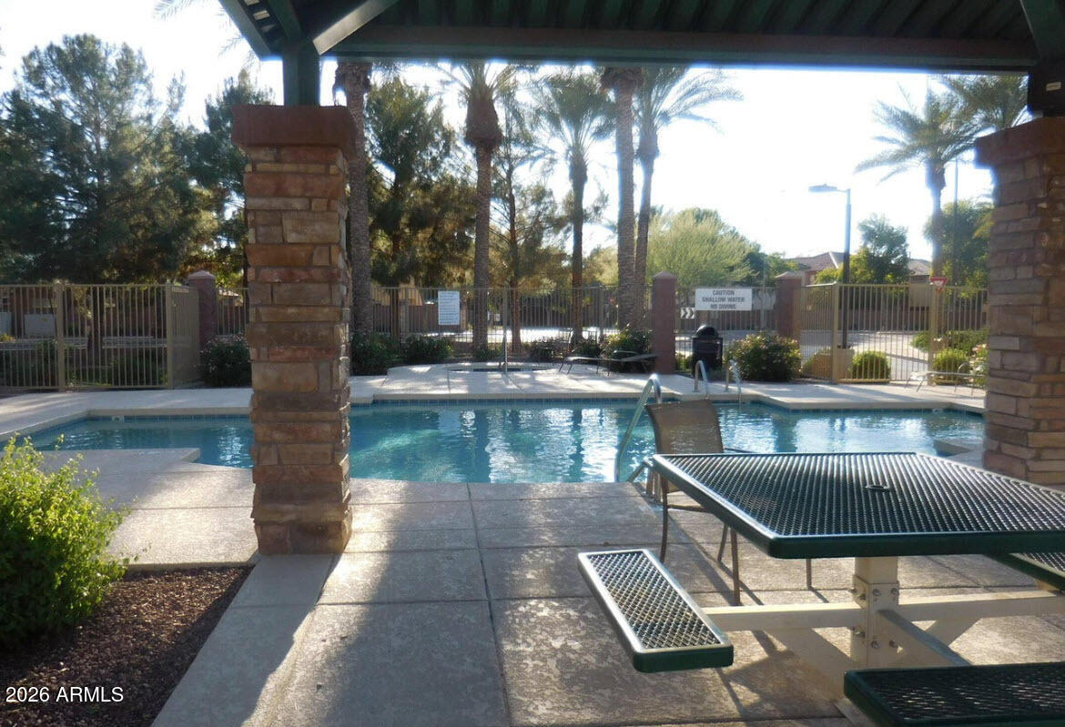 2600 East Springfield Place, Unit 109 Chandler, AZ 85286 - Photo 29 of 38 a view of swimming pool with a patio and a yard