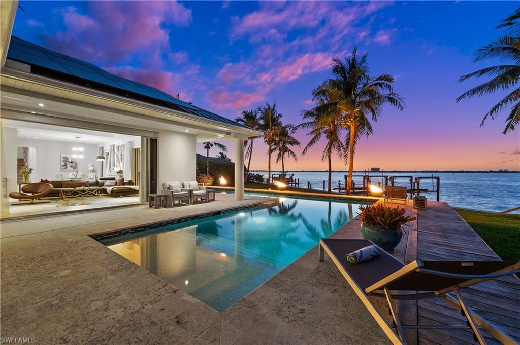 a view of swimming pool with outdoor seating