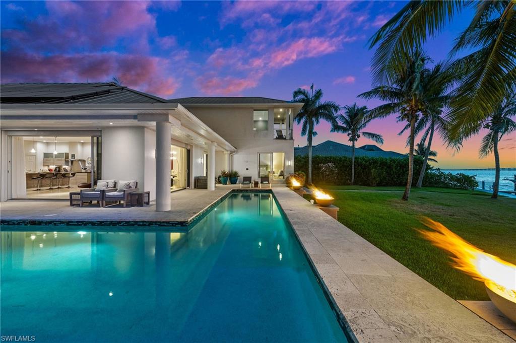 5625 Riverside Drive Cape Coral, FL 33904 - Photo 11 of 50 a view of a house with swimming pool and a yard