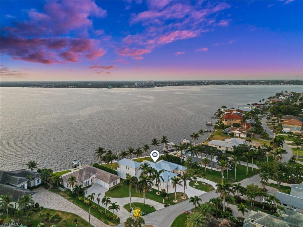 5625 Riverside Drive Cape Coral, FL 33904 - Photo 17 of 50 a view of a lake with a table under an umbrella