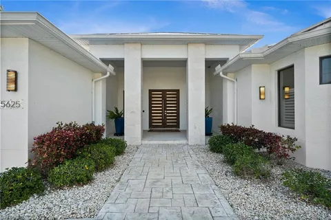 a front view of house with yard and swimming pool