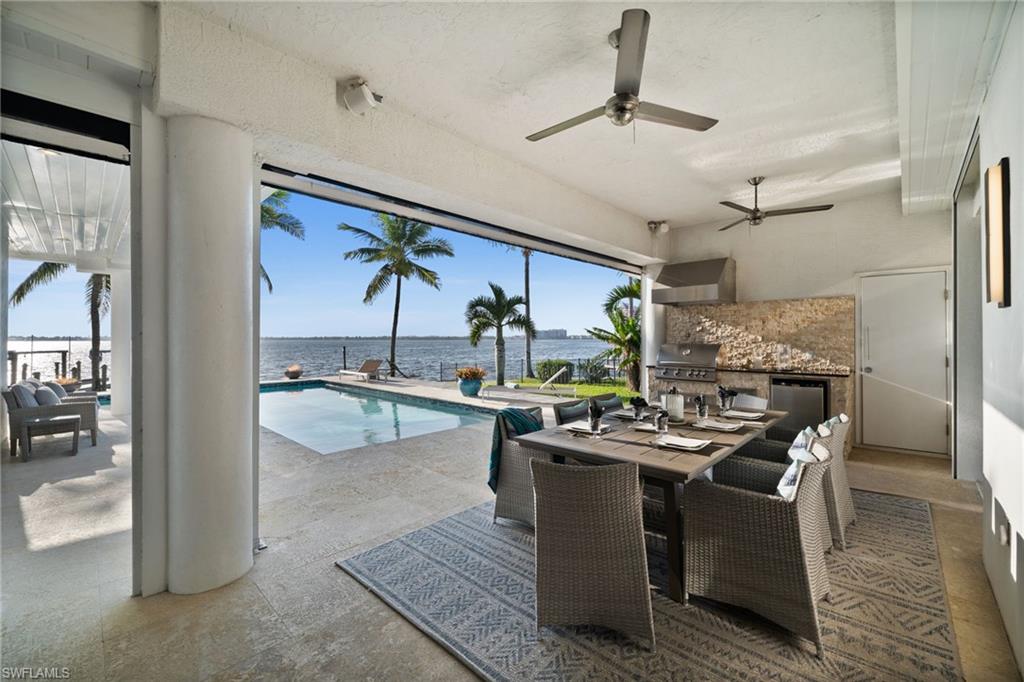 5625 Riverside Drive Cape Coral, FL 33904 - Photo 22 of 50 a room with stainless steel appliances kitchen island granite countertop furniture and a view of kitchen