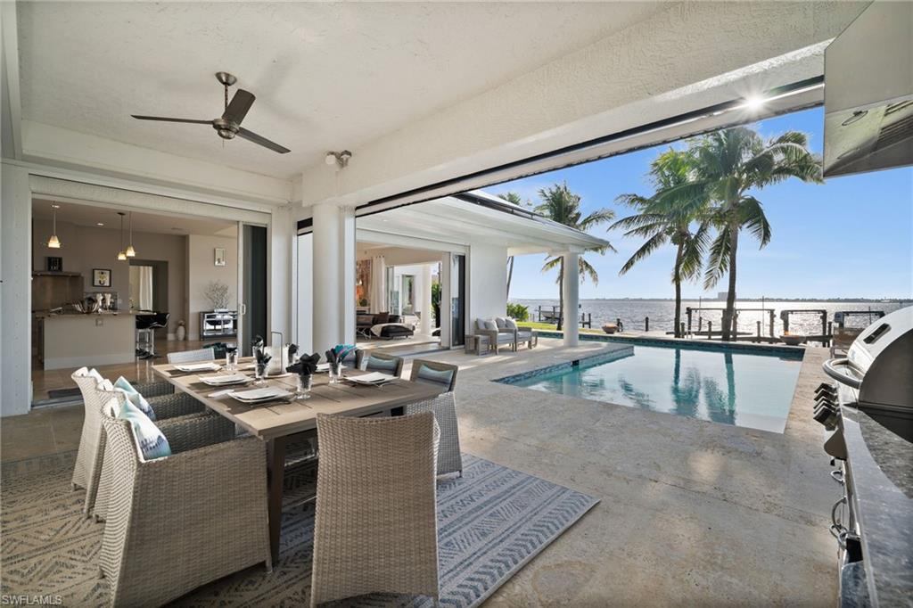 5625 Riverside Drive Cape Coral, FL 33904 - Photo 23 of 50 a dining hall with living room and couches with wooden floor