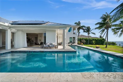 a view of a house with a yard patio and swimming pool