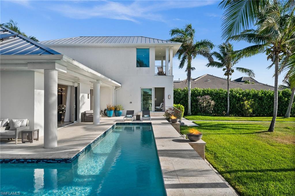 5625 Riverside Drive Cape Coral, FL 33904 - Photo 25 of 50 a view of a house with a yard patio and swimming pool