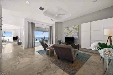 a living room with furniture a dining table and a large window