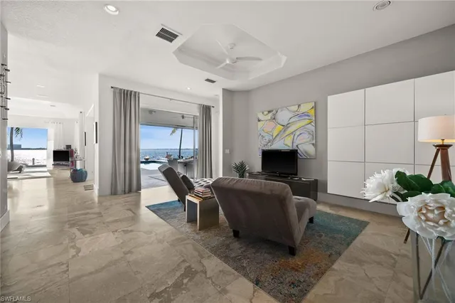 a living room with furniture a dining table and a large window