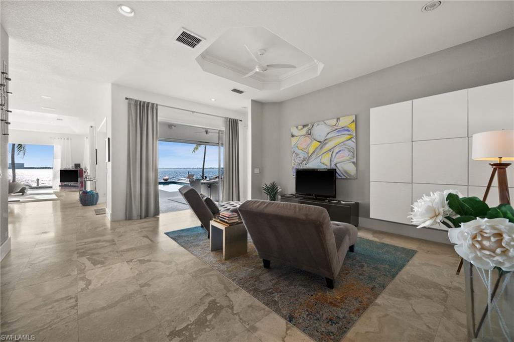 5625 Riverside Drive Cape Coral, FL 33904 - Photo 29 of 50 a living room with furniture and a fireplace