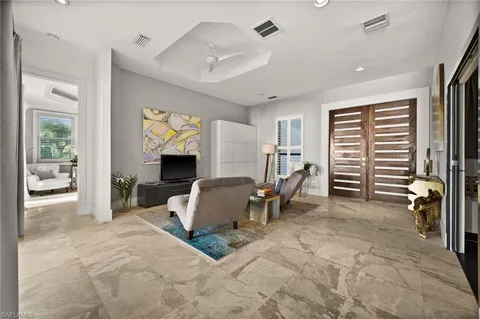 a bedroom with furniture and a large window