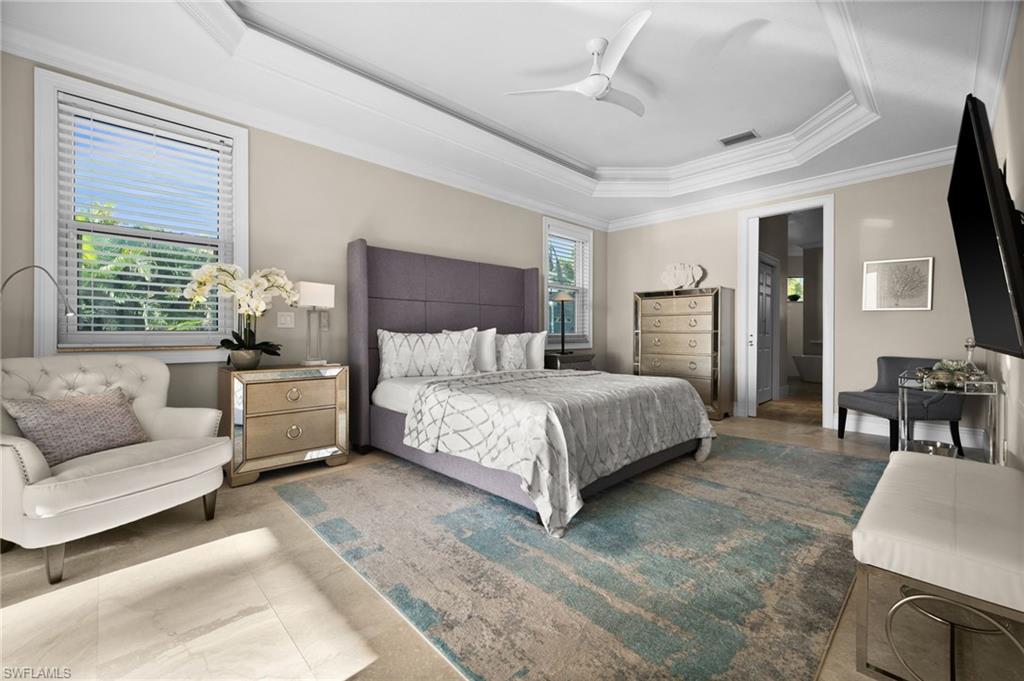 5625 Riverside Drive Cape Coral, FL 33904 - Photo 34 of 50 a bedroom with a large bed couch and windows