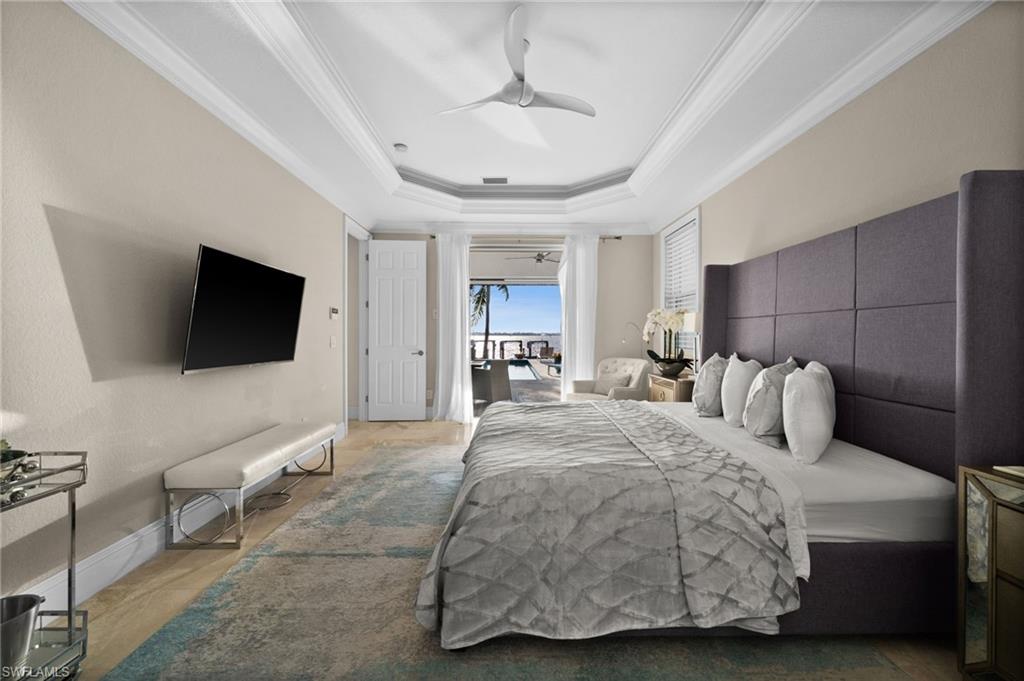 5625 Riverside Drive Cape Coral, FL 33904 - Photo 35 of 50 a spacious bedroom with a bed and a flat screen tv