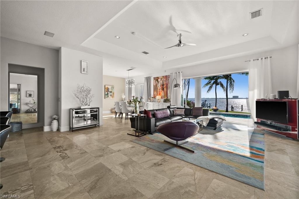 5625 Riverside Drive Cape Coral, FL 33904 - Photo 37 of 50 a living room with furniture and a flat screen tv