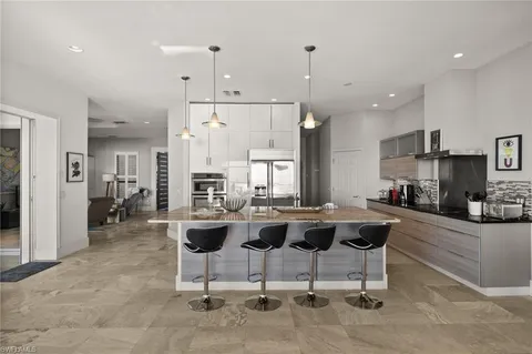a view of a dining room with furniture and a chandelier