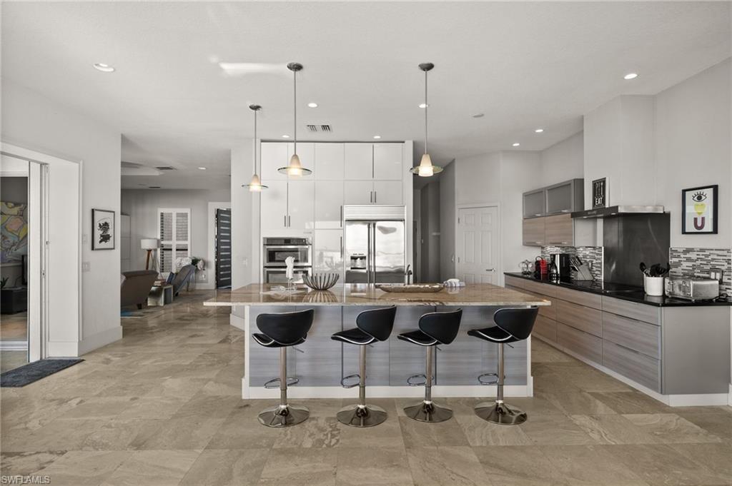 5625 Riverside Drive Cape Coral, FL 33904 - Photo 39 of 50 a view of a kitchen with dining table and chairs