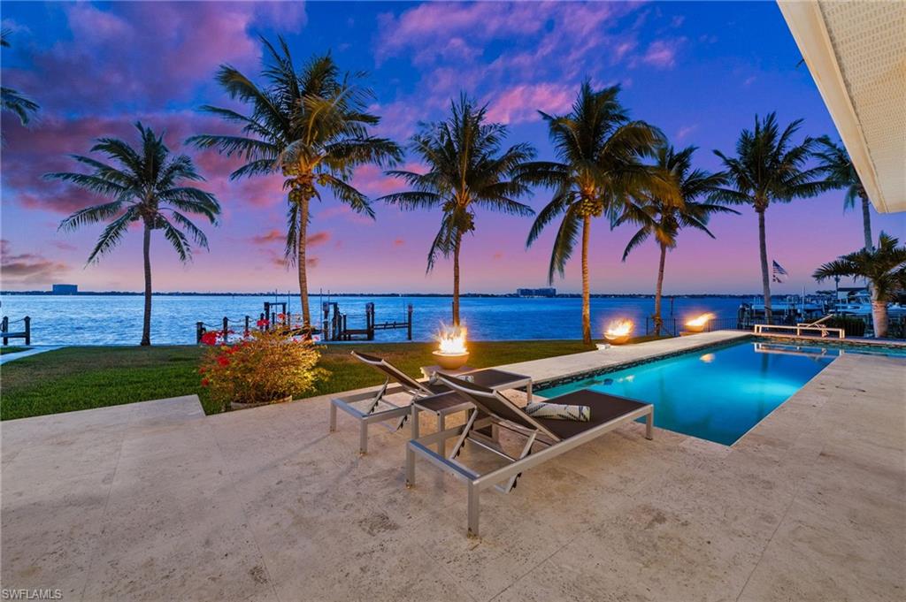 5625 Riverside Drive Cape Coral, FL 33904 - Photo 4 of 50 a swimming pool with outdoor seating and a garden