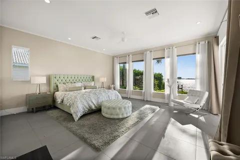 a spacious bedroom with a bed and large window