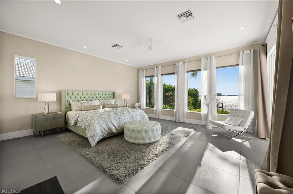 5625 Riverside Drive Cape Coral, FL 33904 - Photo 41 of 50 a bedroom with a bed and glass window