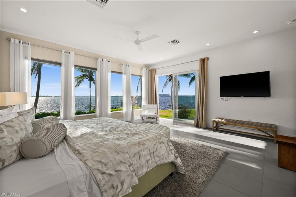 5625 Riverside Drive Cape Coral, FL 33904 - Photo 42 of 50 a spacious bedroom with a bed and large window