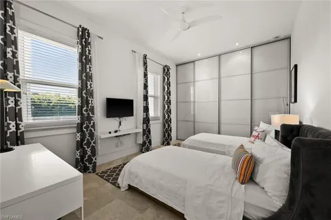 a bedroom with a bed and a flat screen tv