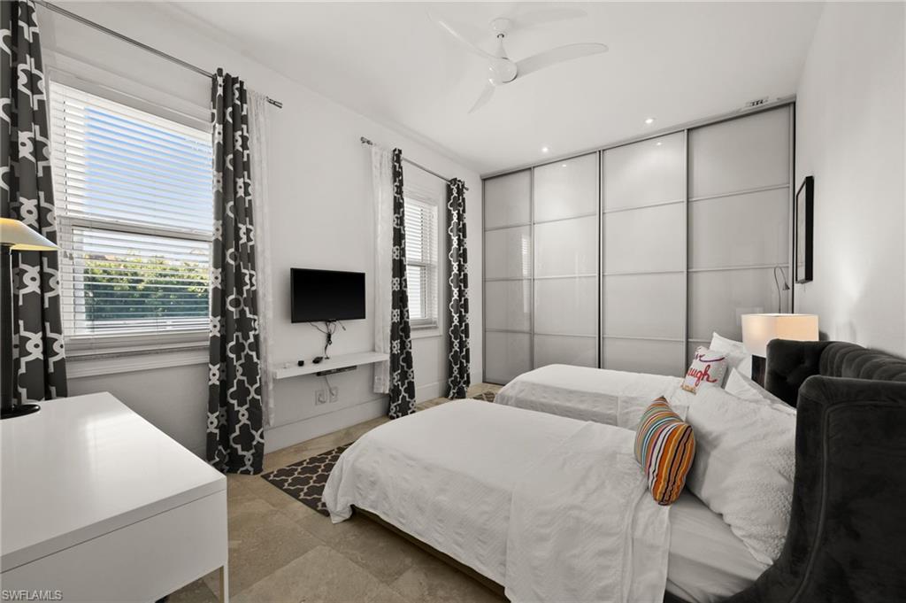 5625 Riverside Drive Cape Coral, FL 33904 - Photo 46 of 50 a bedroom with a bed and a flat screen tv