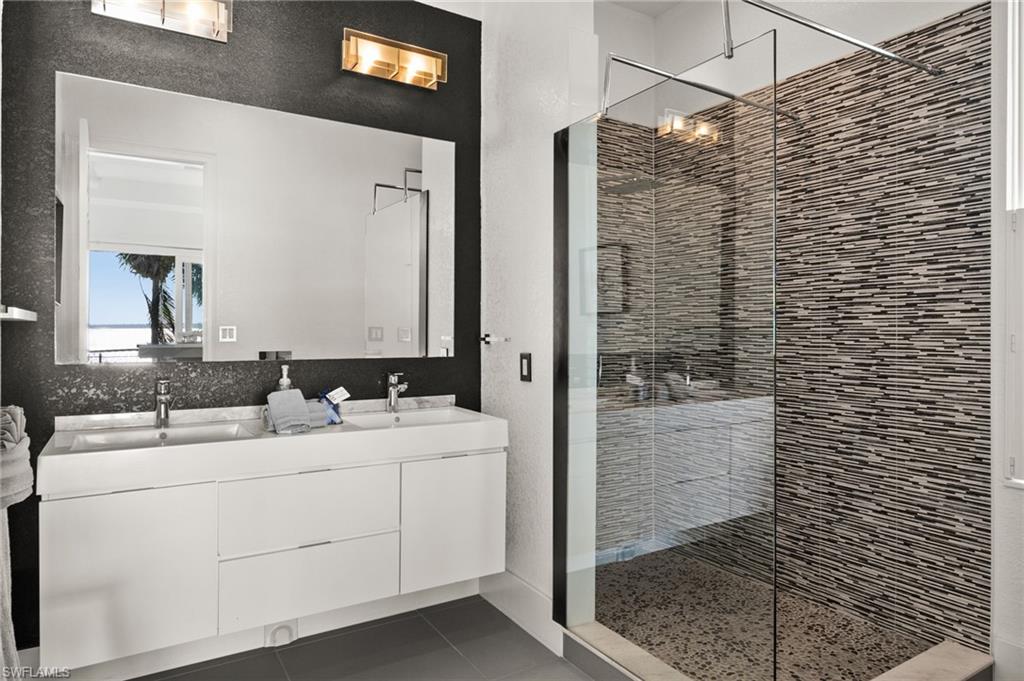 5625 Riverside Drive Cape Coral, FL 33904 - Photo 49 of 50 a bathroom with a sink and a mirror