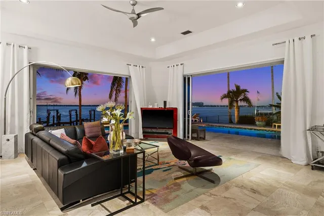 a spacious bedroom with a bed and a flat screen tv