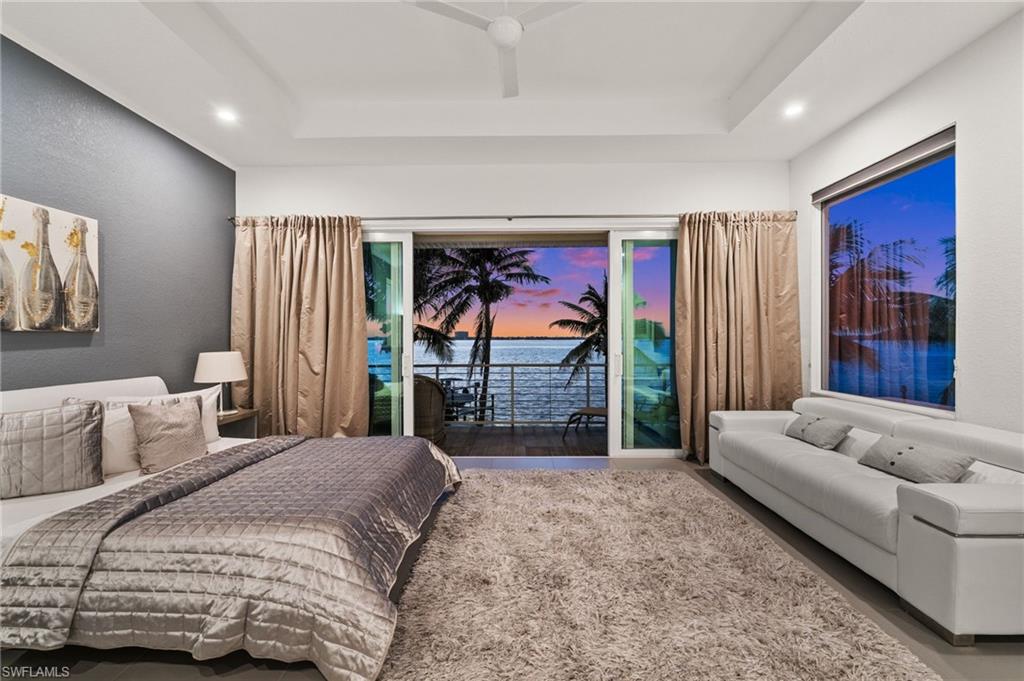 5625 Riverside Drive Cape Coral, FL 33904 - Photo 8 of 50 a bedroom with a large bed and a couch