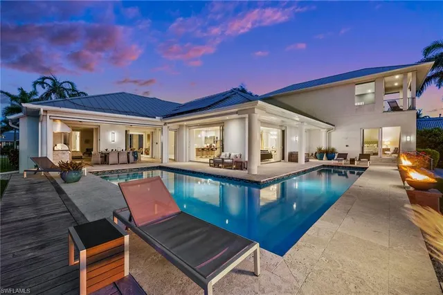 a view of a house with swimming pool and a yard