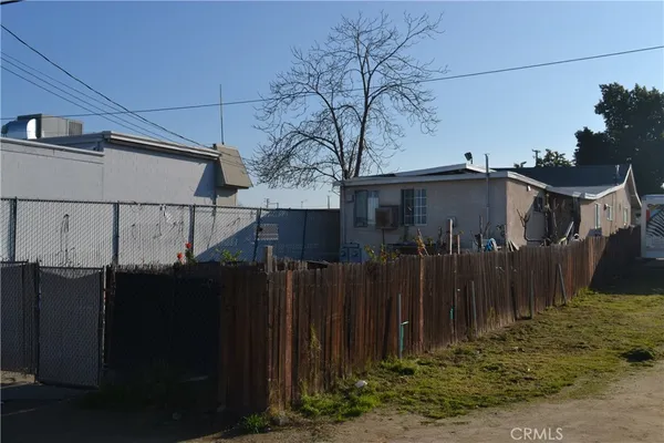 a view of a house with a wooden fence