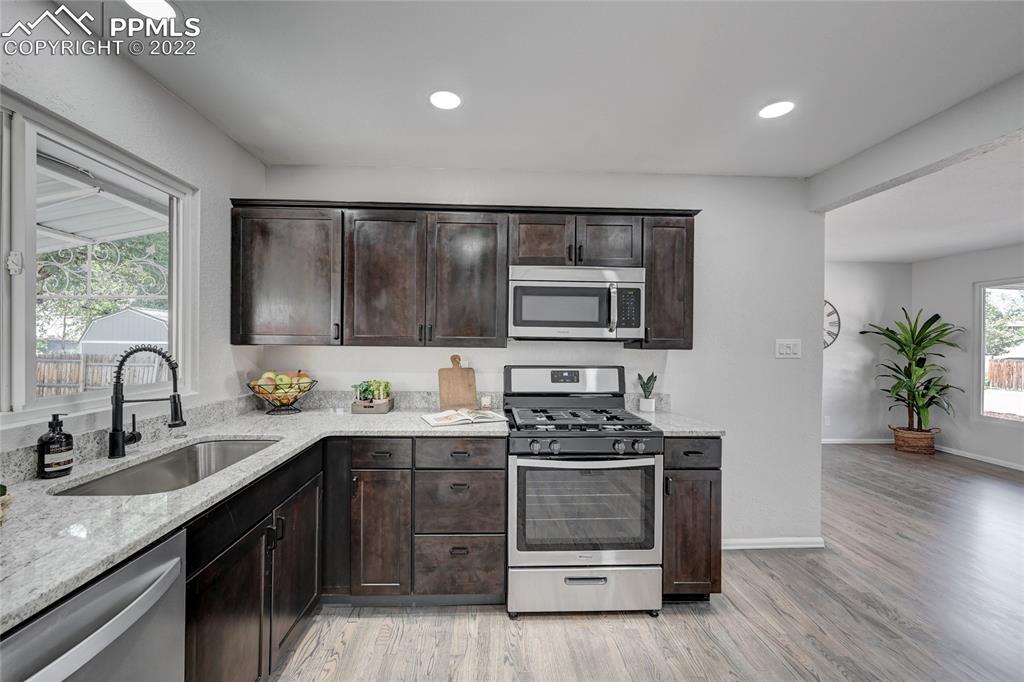 505 Inca Drive Colorado Springs, CO 80911 - Photo 2 of 33 a kitchen with a sink stove and cabinets