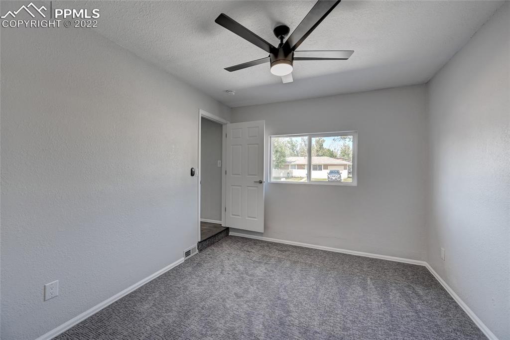 505 Inca Drive Colorado Springs, CO 80911 - Photo 28 of 33 an empty room with a window and a fan