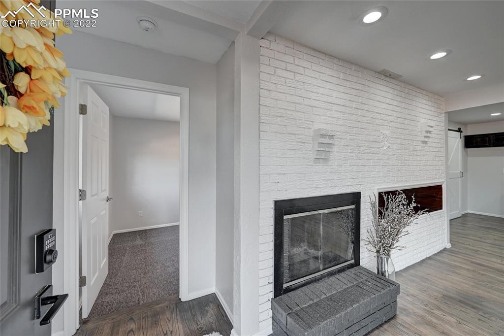 505 Inca Drive Colorado Springs, CO 80911 - Photo 7 of 33 a living room with furniture and a fireplace