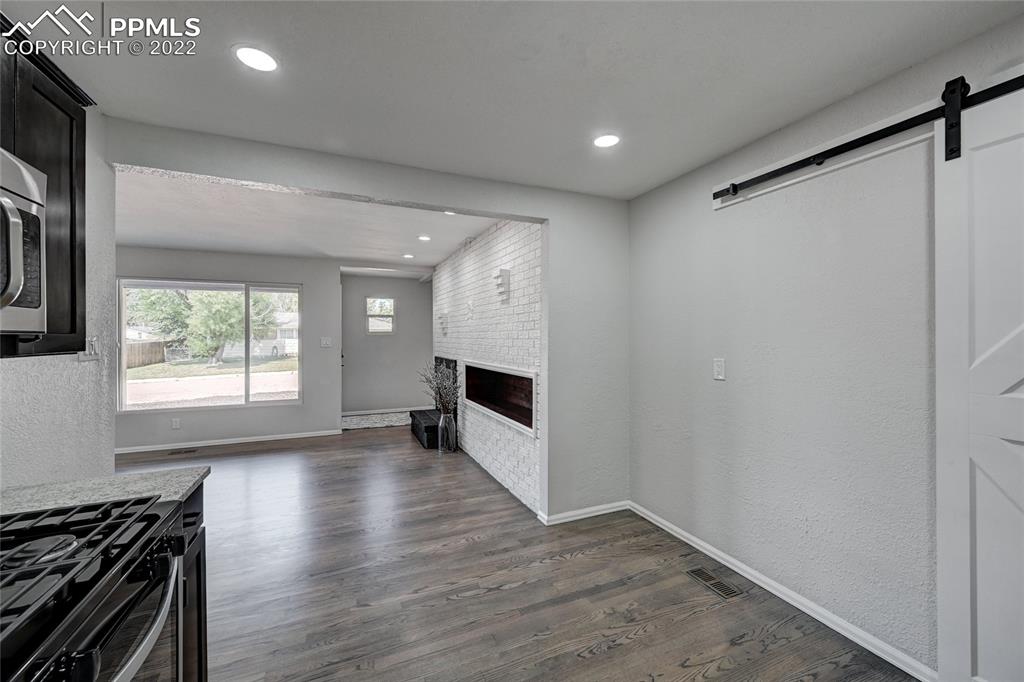 505 Inca Drive Colorado Springs, CO 80911 - Photo 9 of 33 a view of an empty room with a fireplace and a window