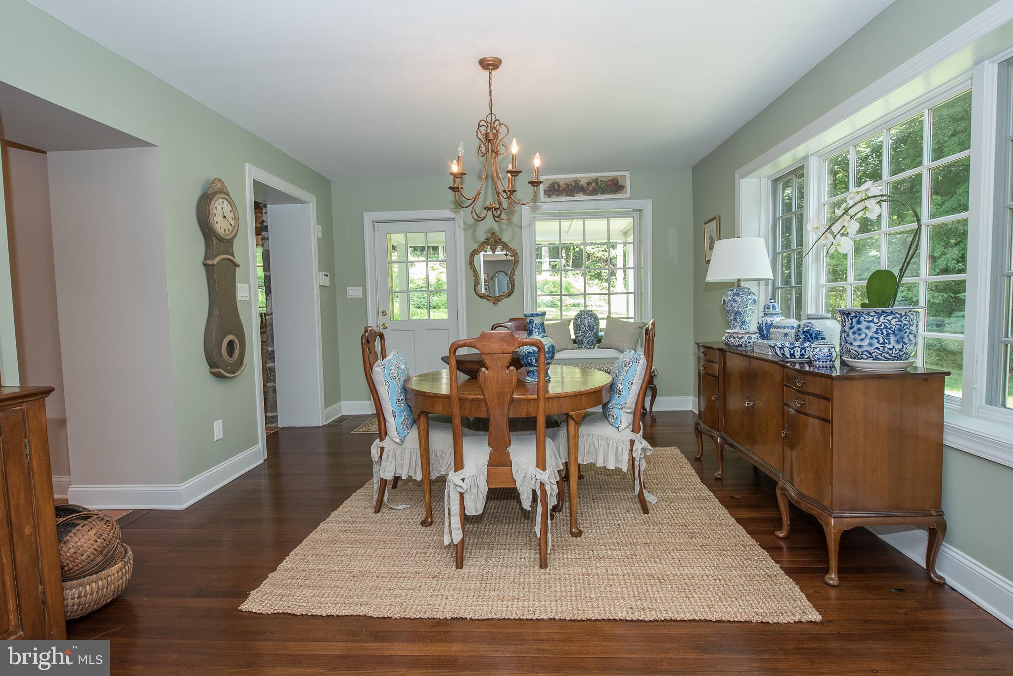 603 Beatty Road Media, PA 19063 - Photo 27 of 84 a dining room with wooden floor a chandelier a wooden table and chairs
