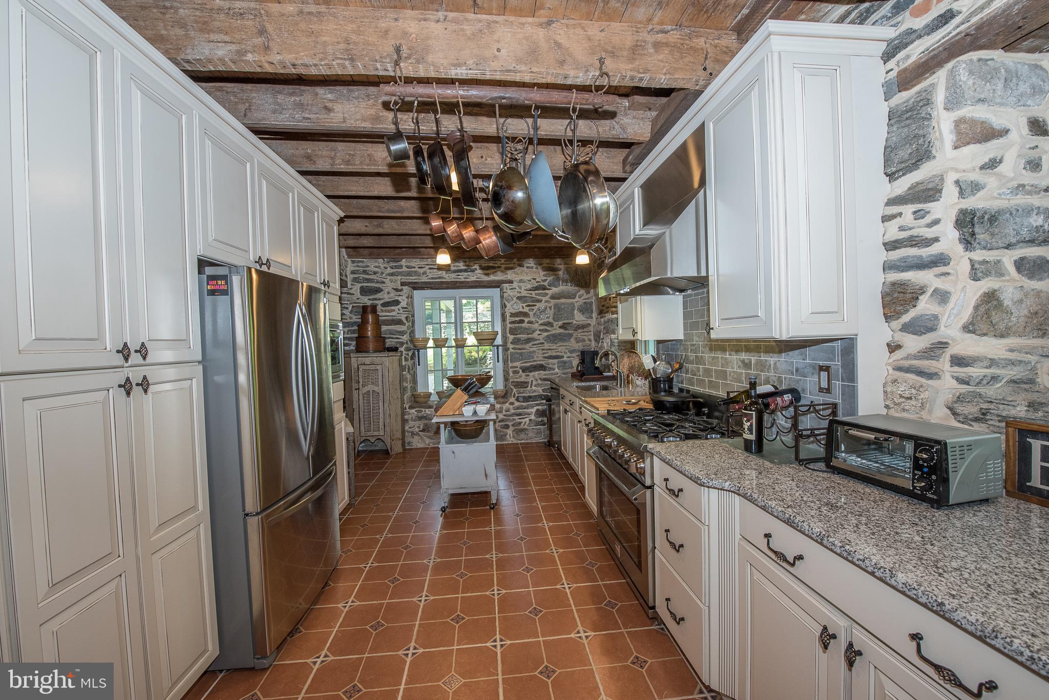 603 Beatty Road Media, PA 19063 - Photo 36 of 84 a kitchen with stainless steel appliances granite countertop a sink stove and refrigerator