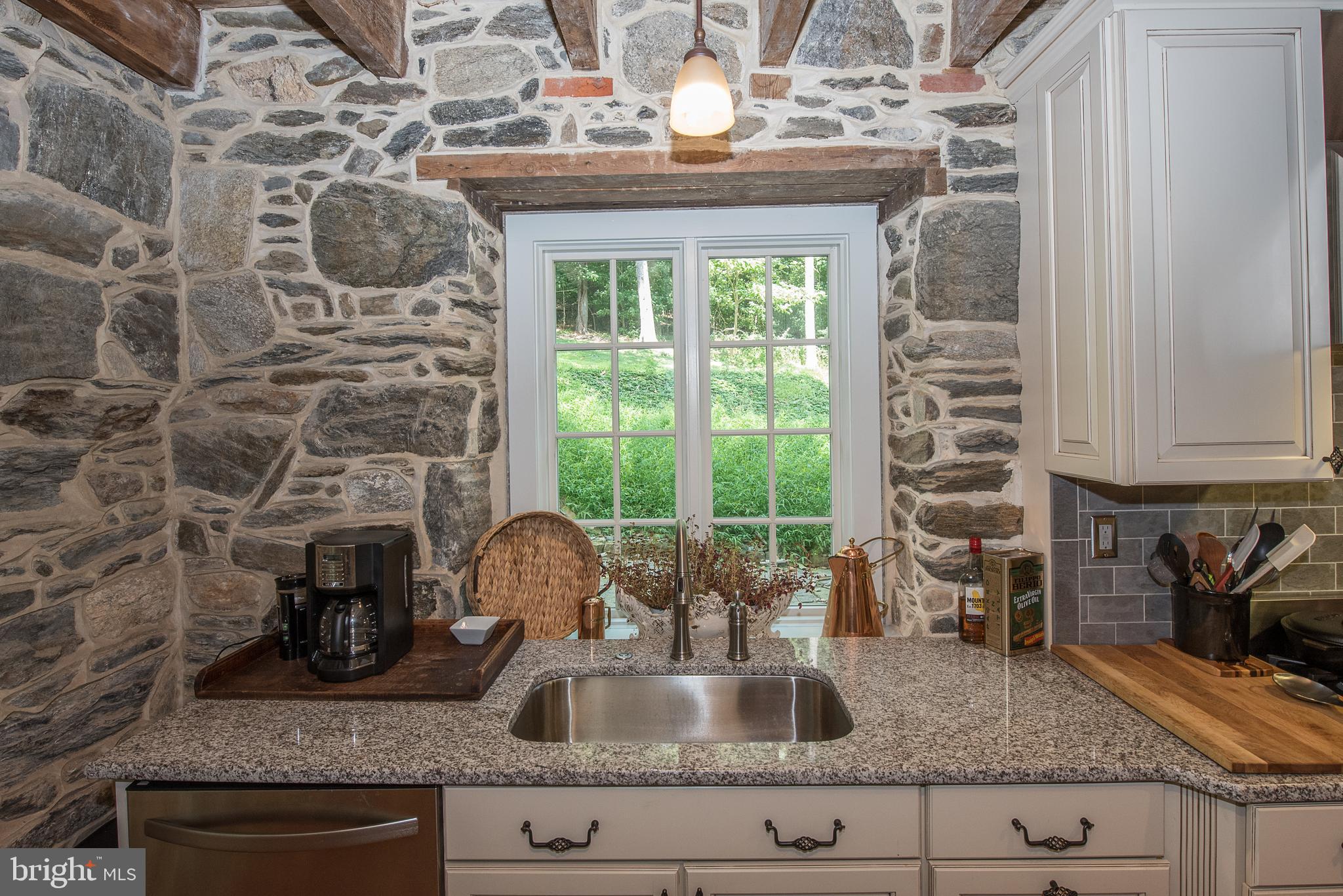 603 Beatty Road Media, PA 19063 - Photo 39 of 84 a kitchen with granite countertop a sink and a wooden floor
