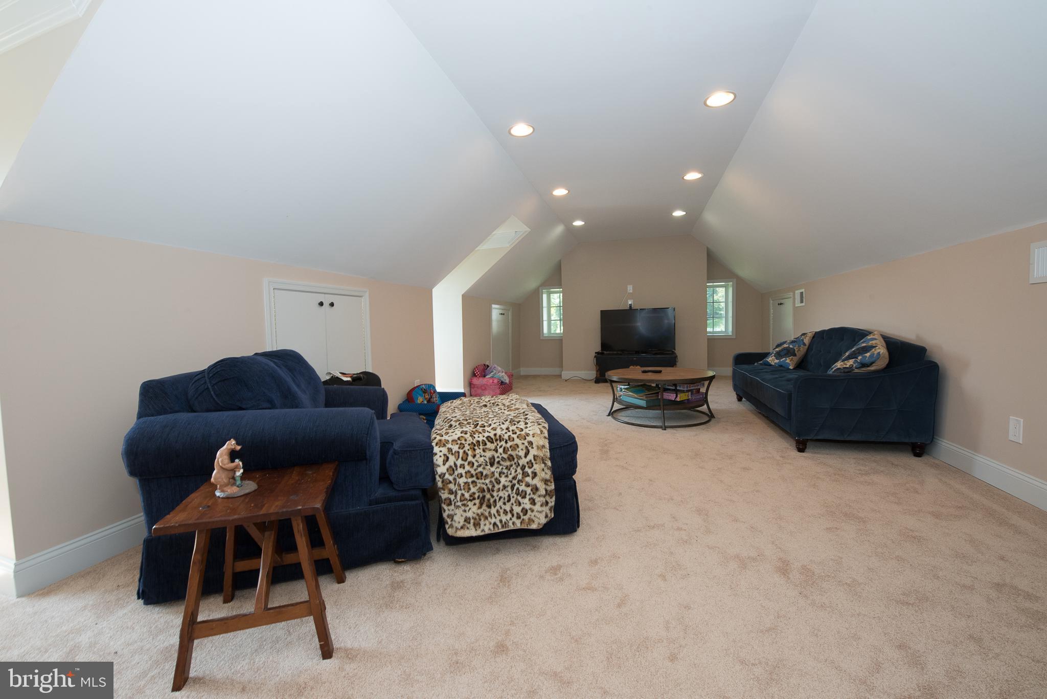 603 Beatty Road Media, PA 19063 - Photo 43 of 84 a living room with furniture a flat screen tv and a fireplace
