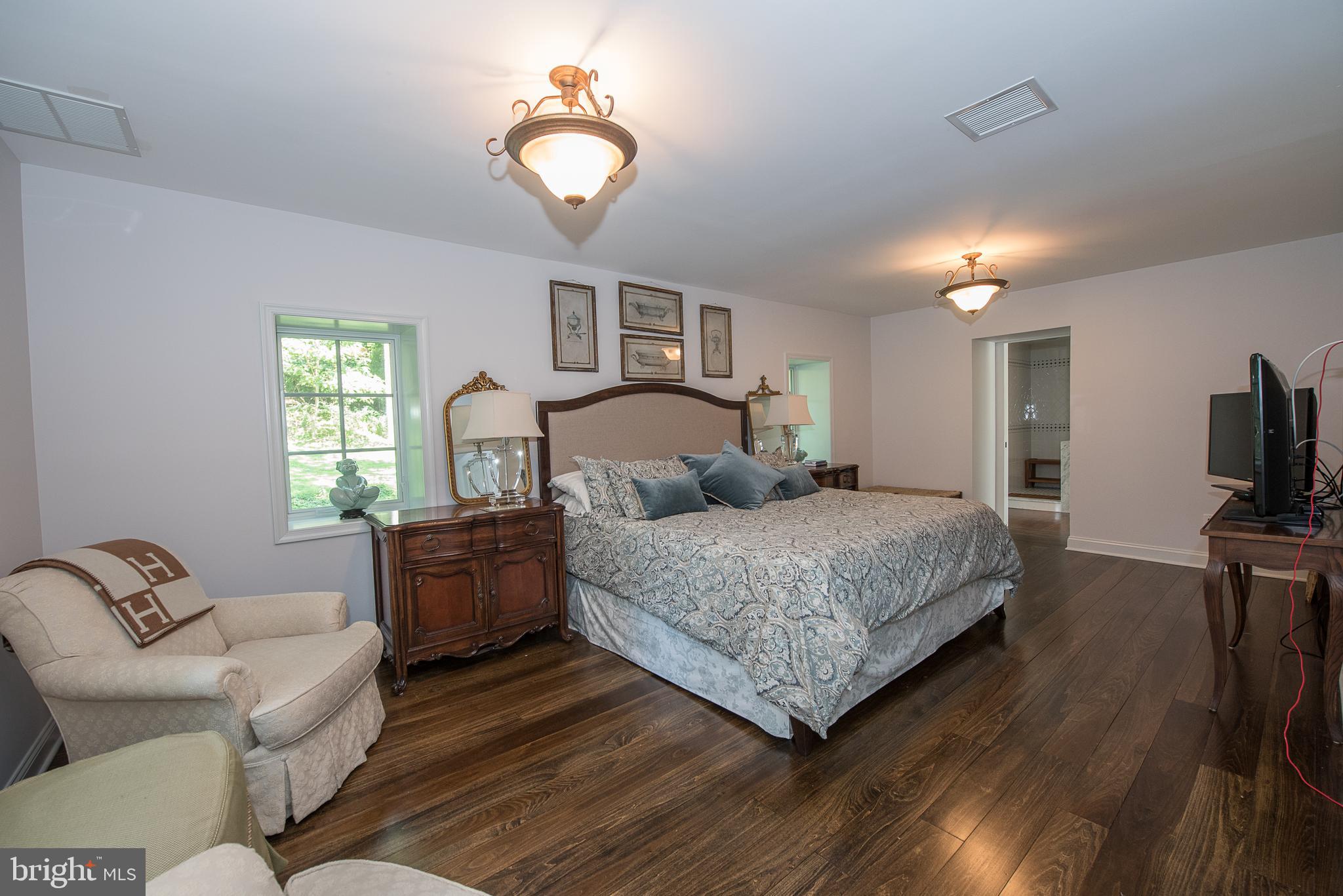603 Beatty Road Media, PA 19063 - Photo 48 of 84 a bedroom with a large bed a flat tv screen and a dresser