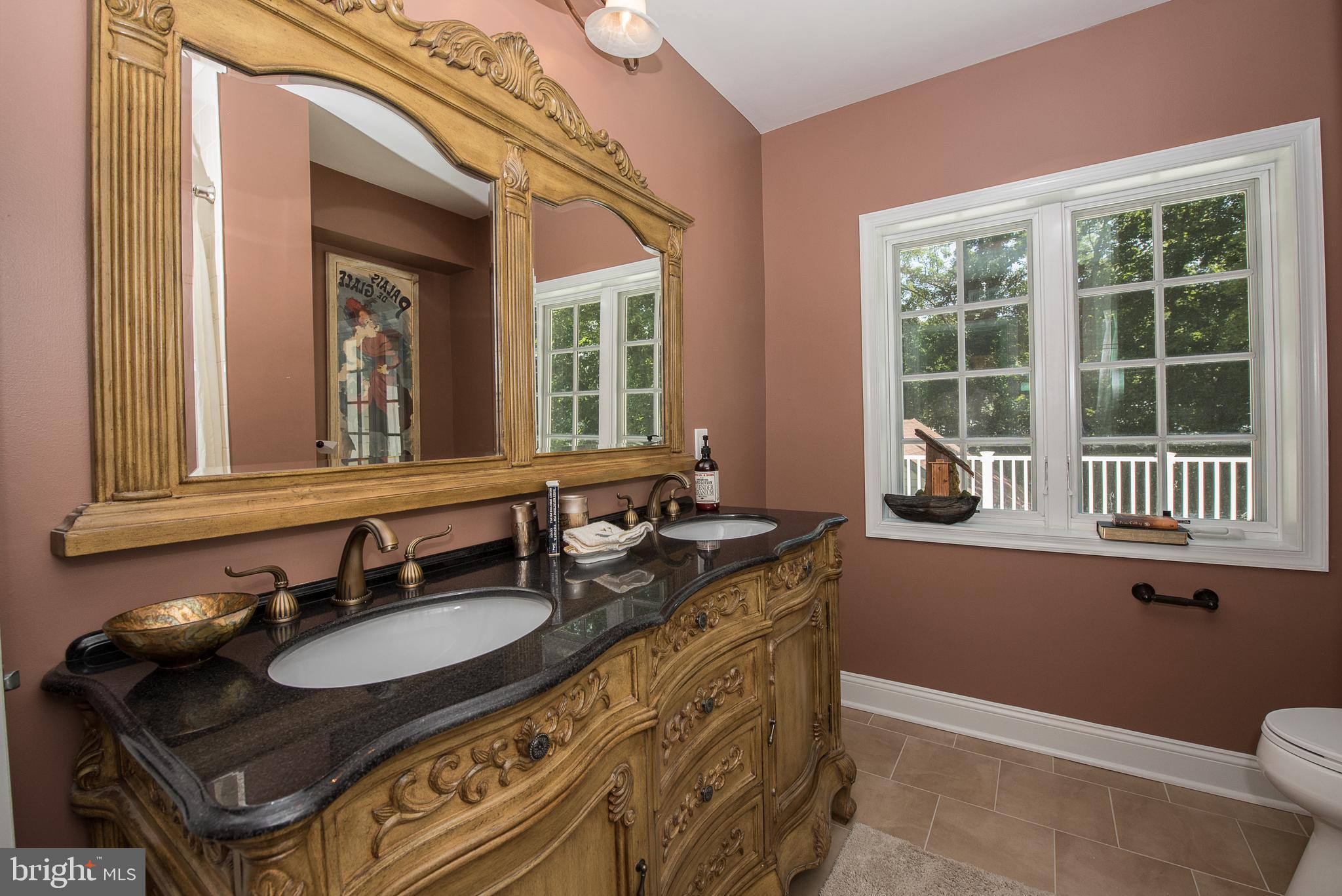 603 Beatty Road Media, PA 19063 - Photo 56 of 84 a bathroom with a granite countertop sink a toilet a mirror and a window