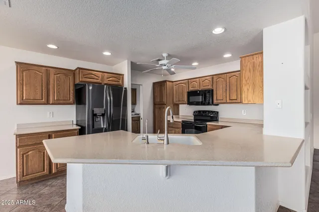a kitchen with stainless steel appliances a sink and a refrigerator