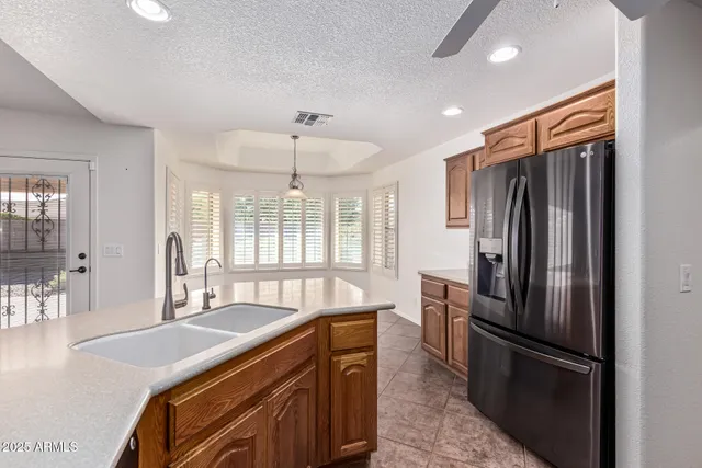 a kitchen with stainless steel appliances granite countertop a refrigerator and a sink