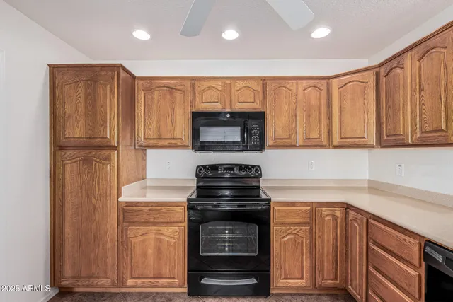 a kitchen with granite countertop a stove and a microwave
