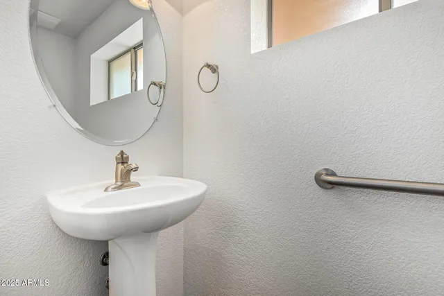 a bathroom with a sink a mirror and a shower