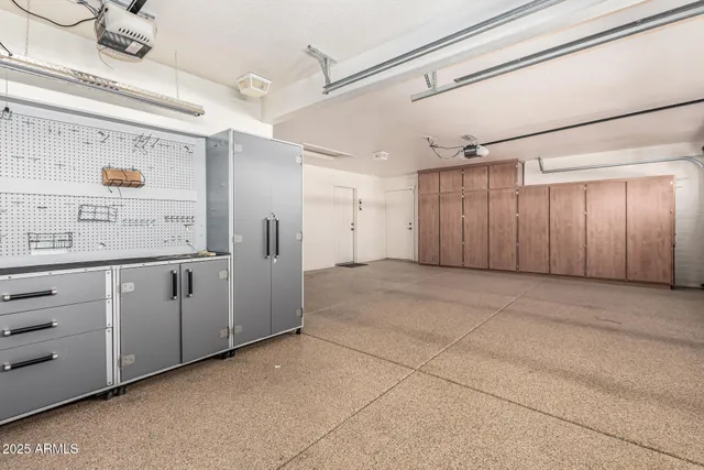 a view of a kitchen with refrigerator and window