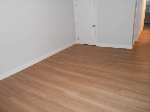 a view of front door with wooden floor