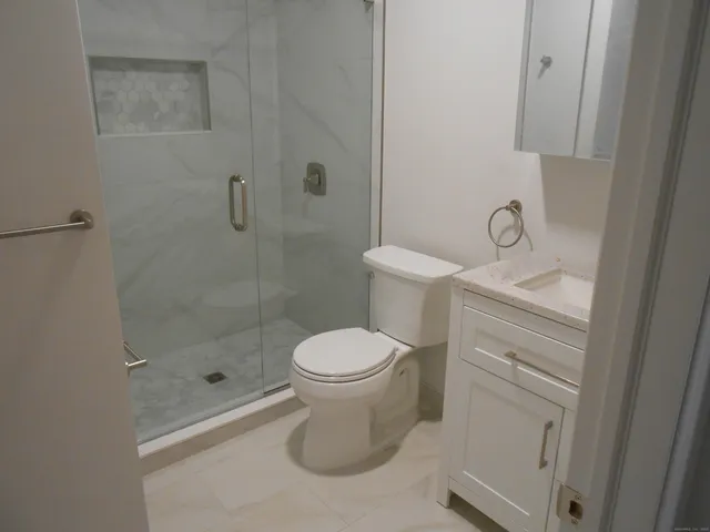 a bathroom with a toilet and a shower